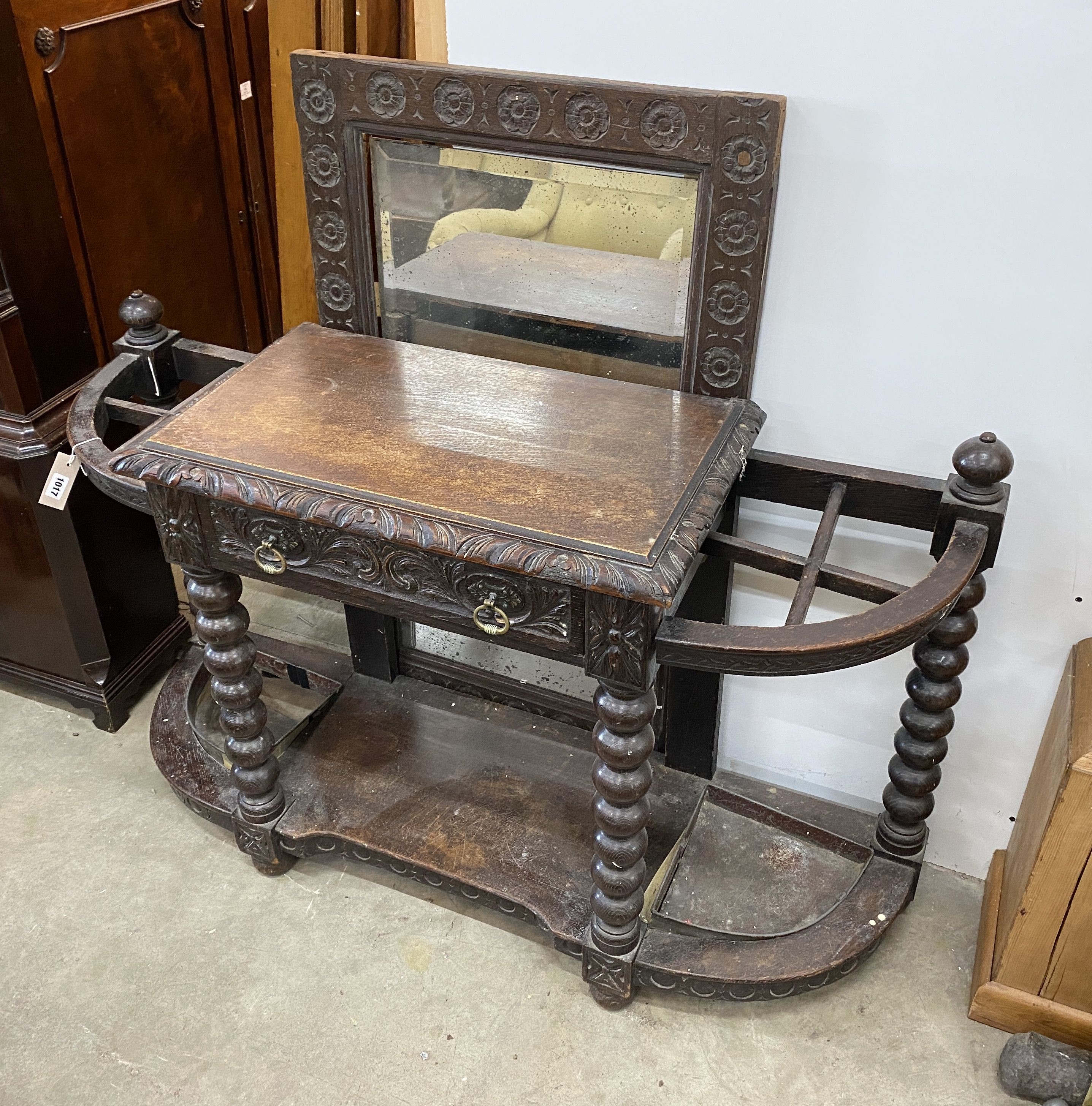 A late Victorian carved oak hall stand with mirror, width 125cm